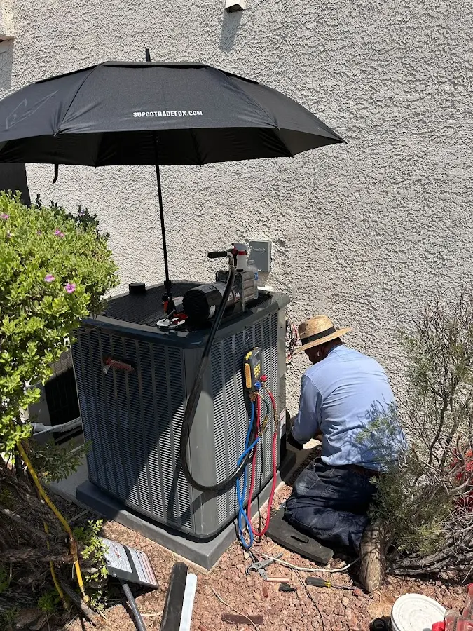 HVAC technician performing outdoor AC maintenance in Tontitown